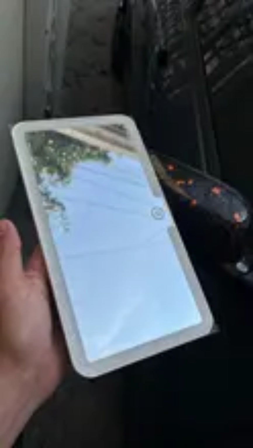 Real RivoMoto LED visor mirror shown by hand
